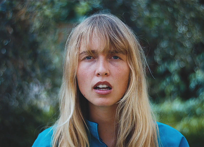 a woman with long blonde hair is staring at the camera