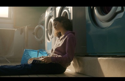 a woman sitting in front of a washing machine