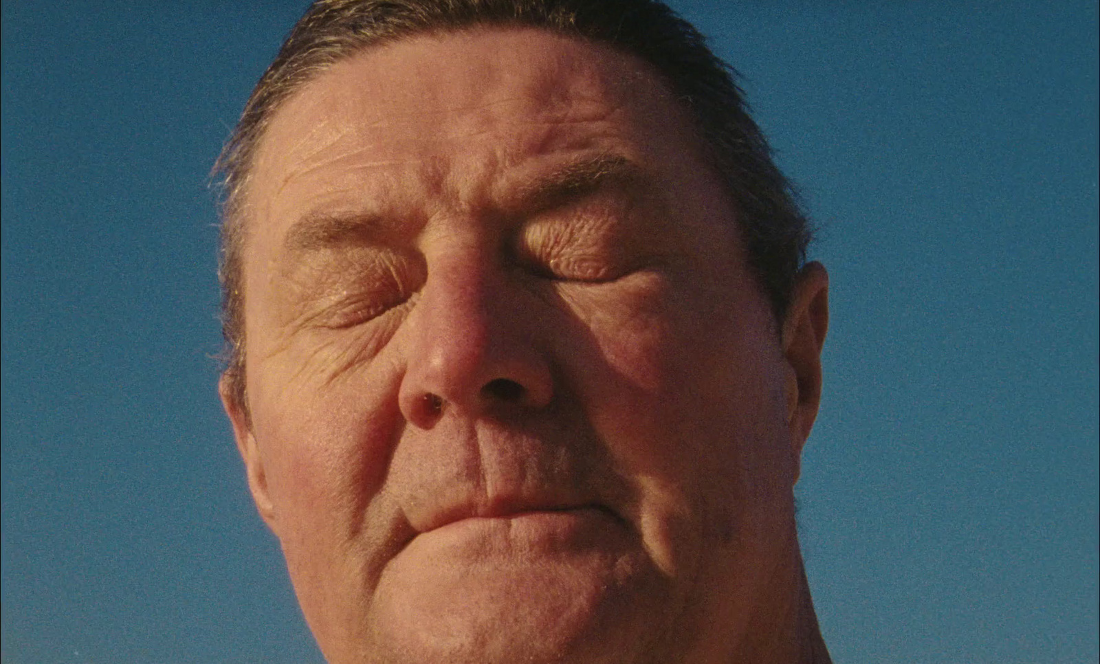 a close up of a man with his eyes closed