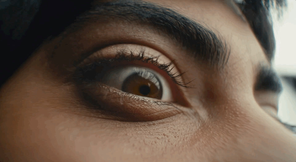 a close up of a person's eye with a blurry background