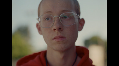 a man wearing glasses and a red hoodie