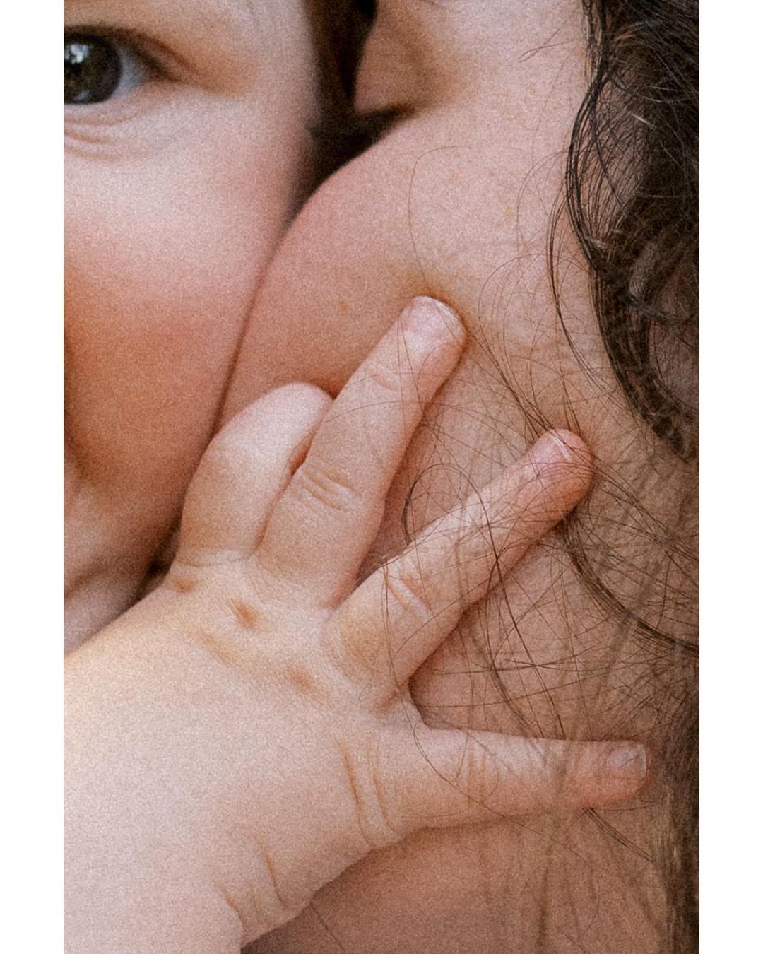 a close up of a person kissing a baby