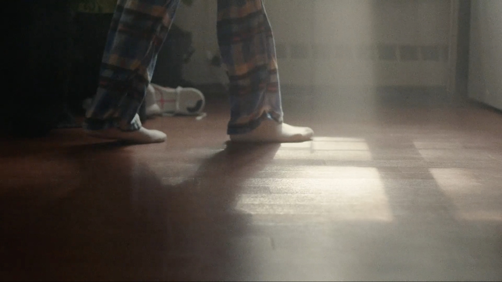 a person standing on a hard wood floor