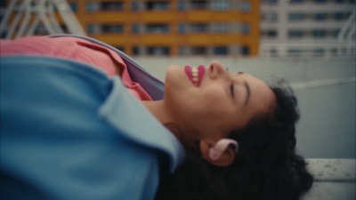 a woman is laying down with her eyes closed