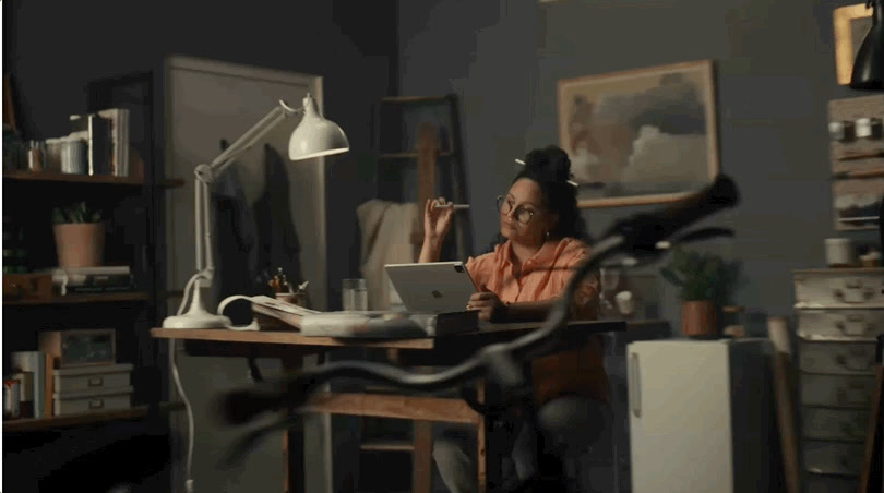 a woman sitting at a desk with a laptop computer