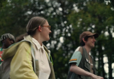 a group of people walking in the woods