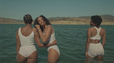 three women in white bathing suits in the water