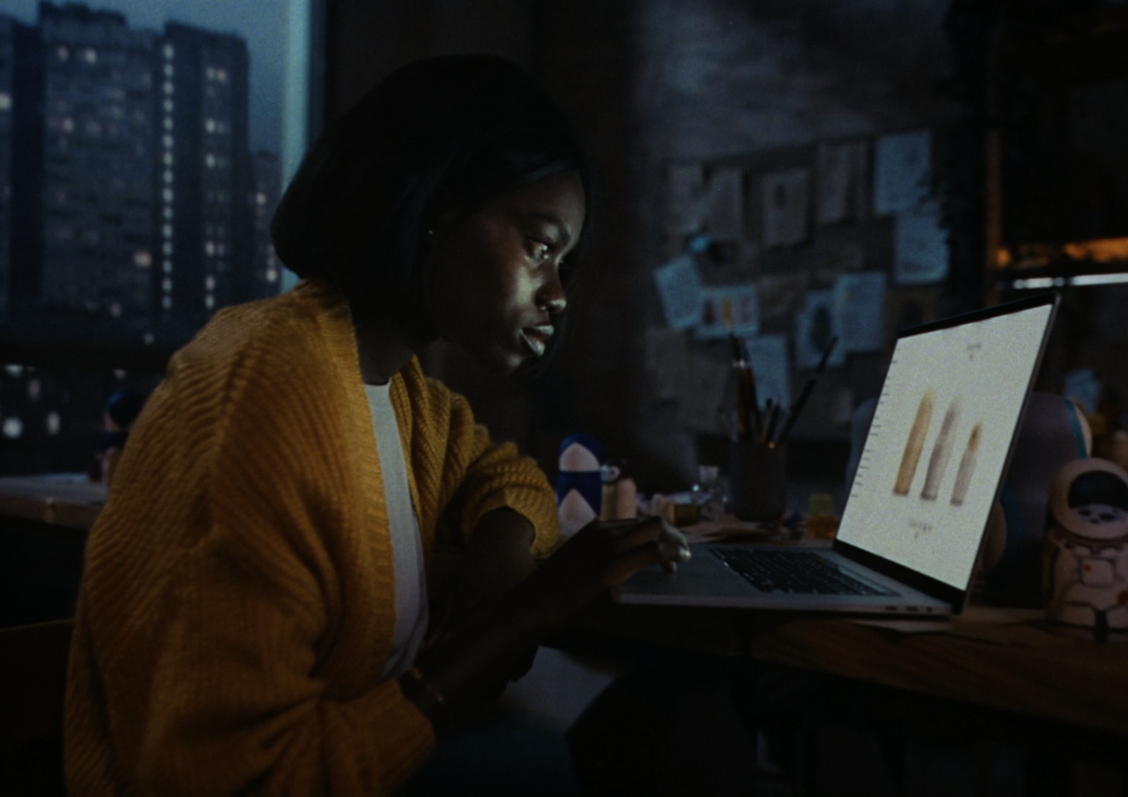 a woman sitting in front of a laptop computer