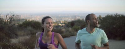 a man and a woman running on a trail