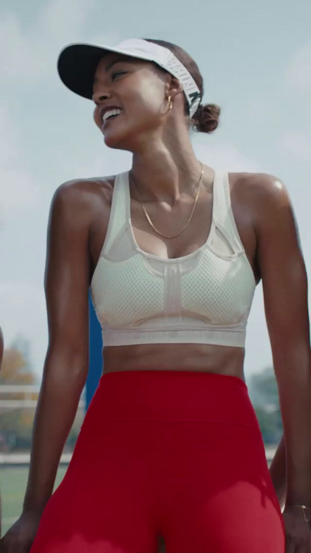 a woman in a sports bra top and red shorts