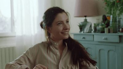 a woman sitting at a table with a plate of food