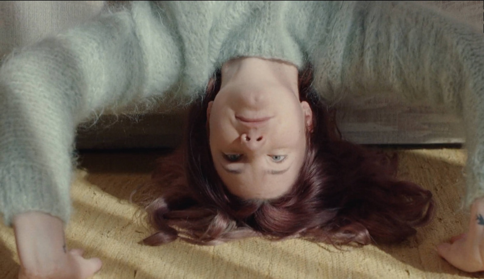 a woman is upside down on the floor