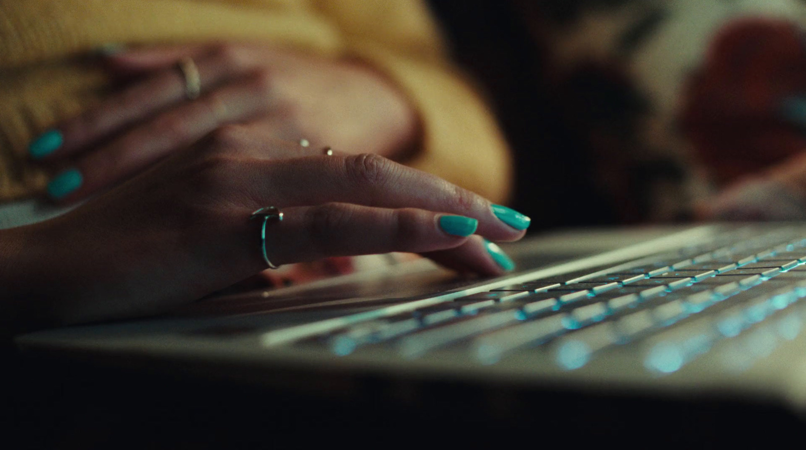 a close up of a person typing on a laptop