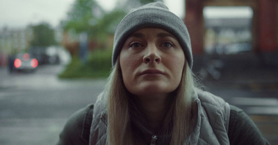  a woman in a hat looking up at something