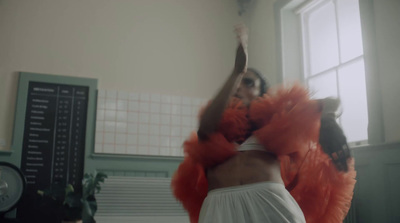 a woman in a white dress dancing in a room