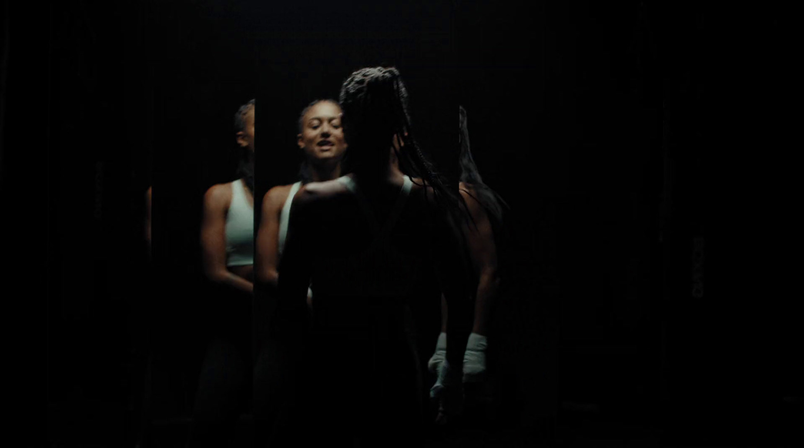 a group of women standing in a dark room