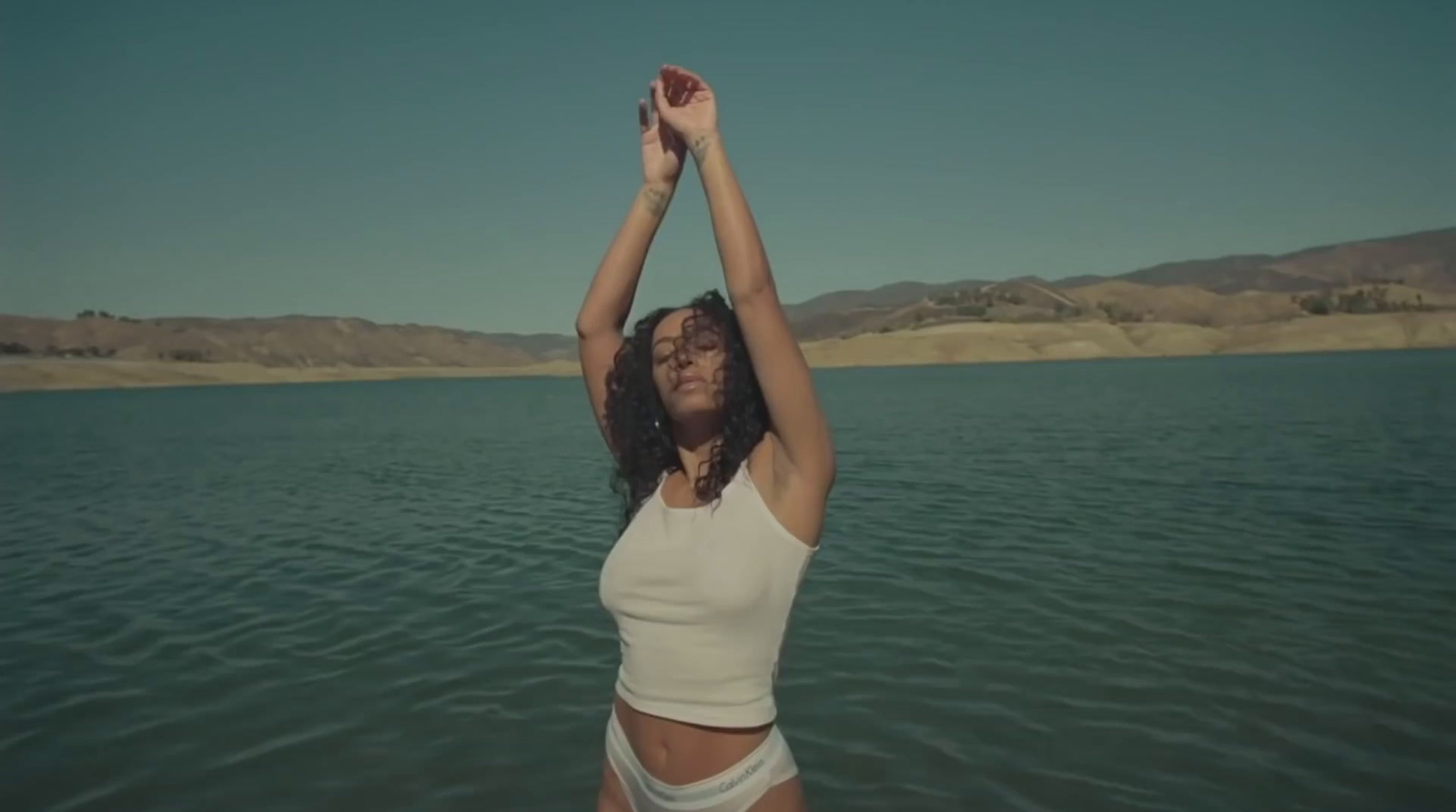 a woman standing in a body of water