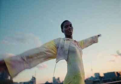 a woman with her arms outstretched in the air