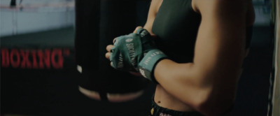 a close up of a person wearing boxing gloves