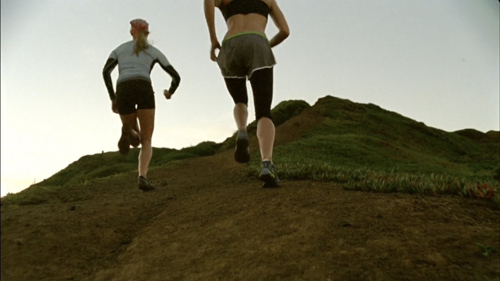 a couple of people that are running down a hill