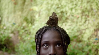 a woman with a butterfly on her head