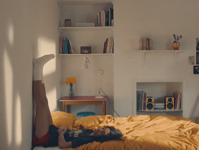 a girl laying on a bed in a room