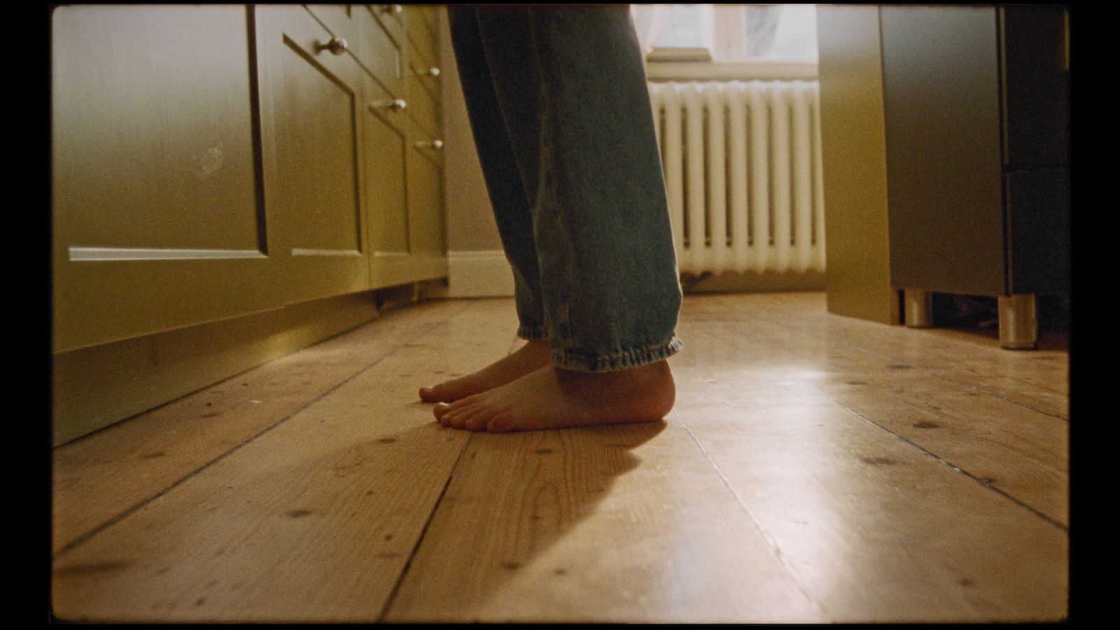 a person standing on a hard wood floor