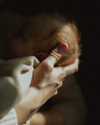 a person holding a baby in their arms