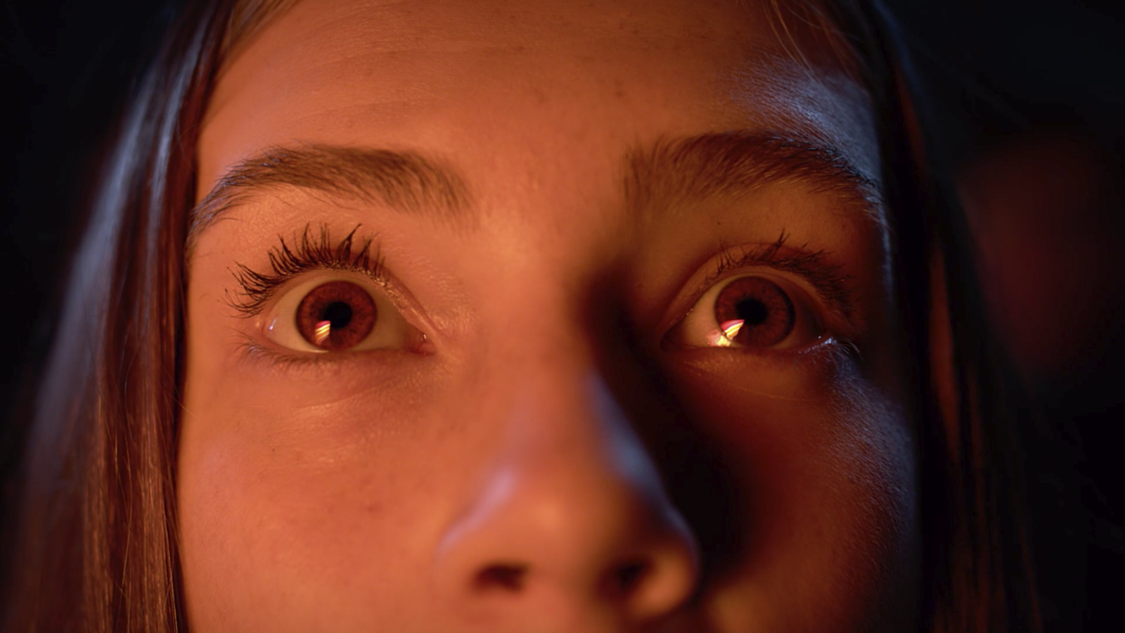 a close up of a woman's face with brown eyes