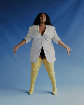 a woman in a white jacket and yellow pants