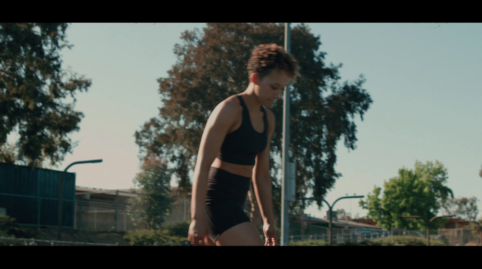 a woman in a black sports bra and black shorts