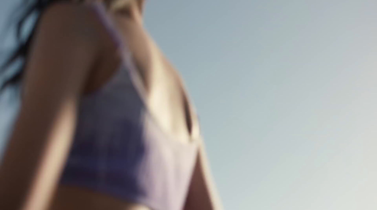 a woman in a bikini holding a frisbee