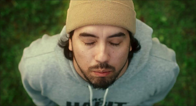 a man with his eyes closed wearing a beanie