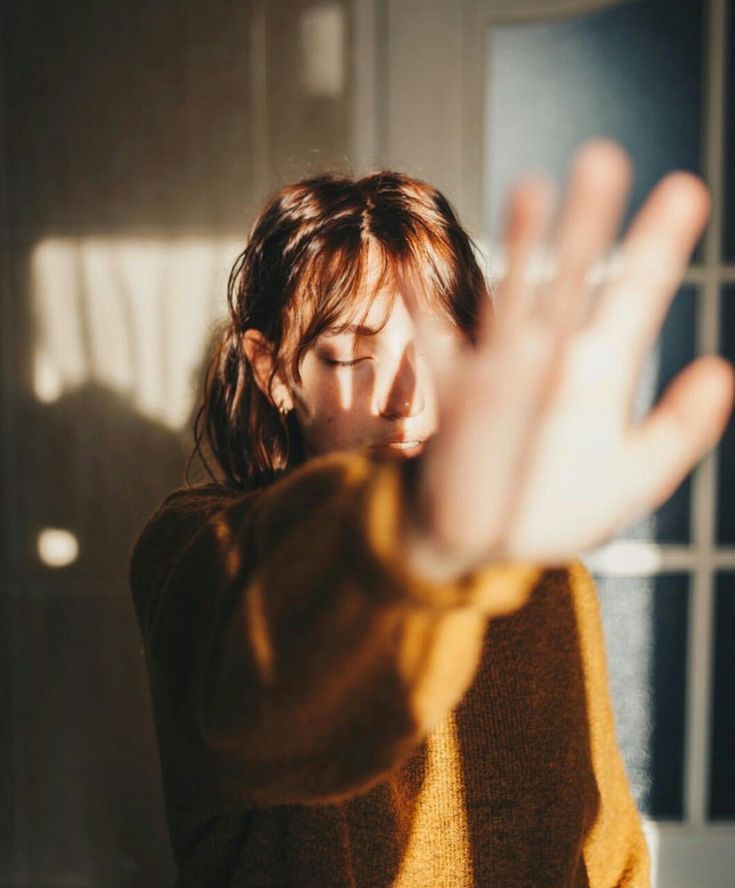 a woman is holding her hands up in the air