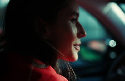 a woman sitting in a car with her head out the window