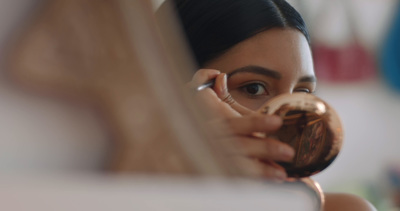 a woman looking at her reflection in a mirror