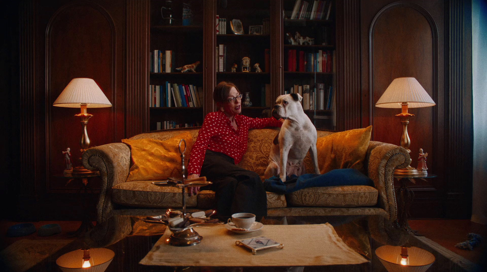 a woman sitting on a couch with a dog on her lap