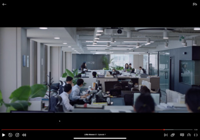 a group of people sitting at desks in an office