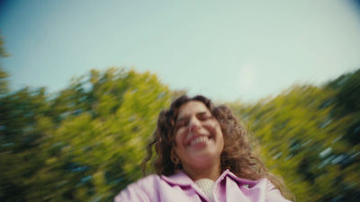 a woman in a pink coat holding a frisbee