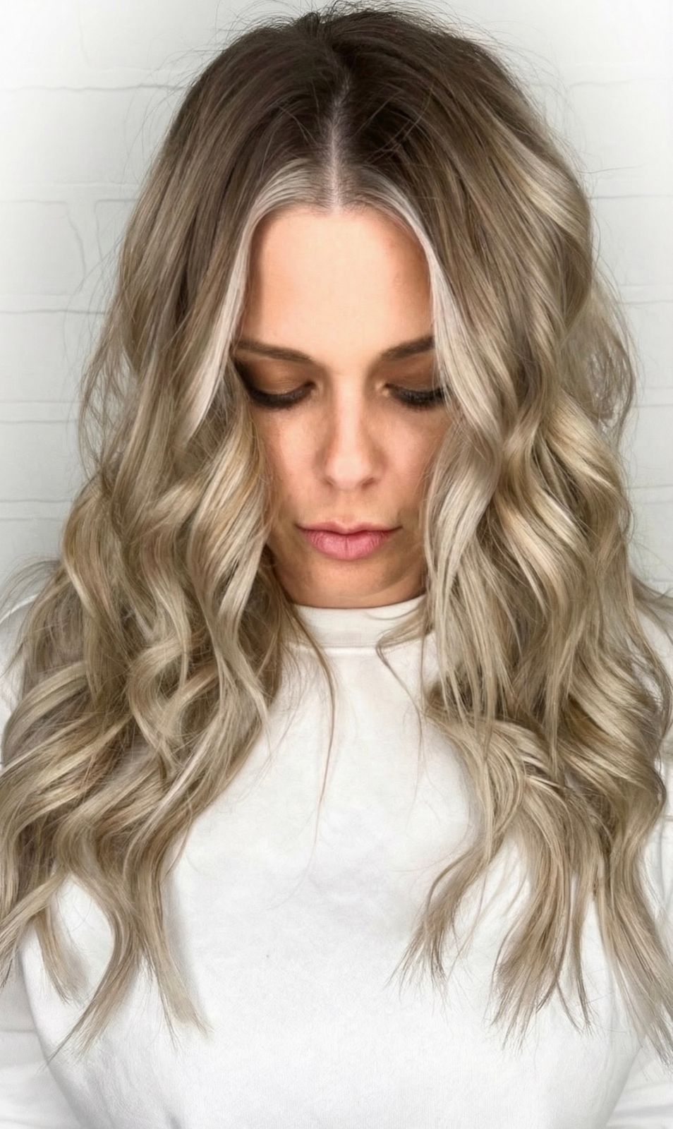 a woman with blonde hair wearing a white shirt