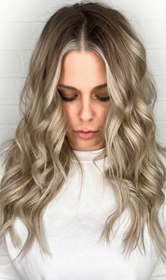 a woman with blonde hair wearing a white shirt