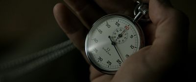 a person holding a stopwatch in their hand