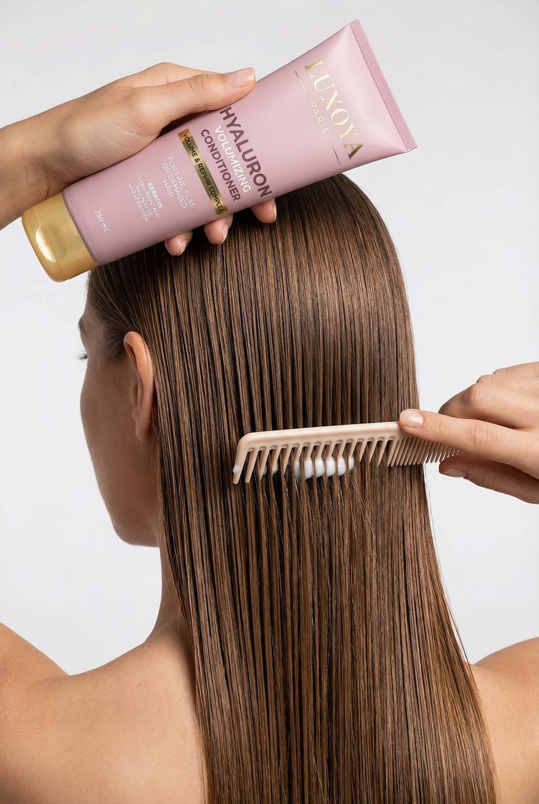 a woman is brushing her hair with a comb