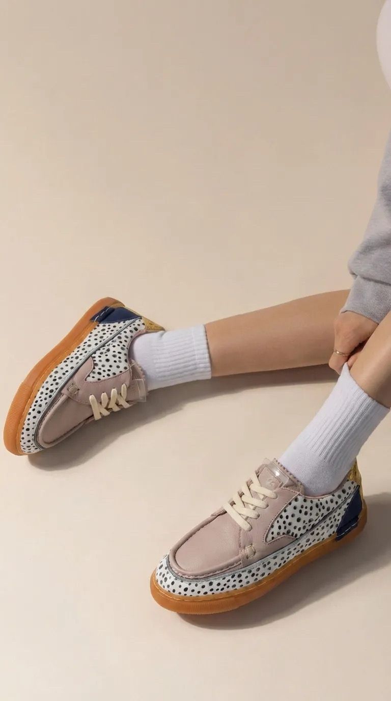 a person sitting on the ground wearing a pair of shoes