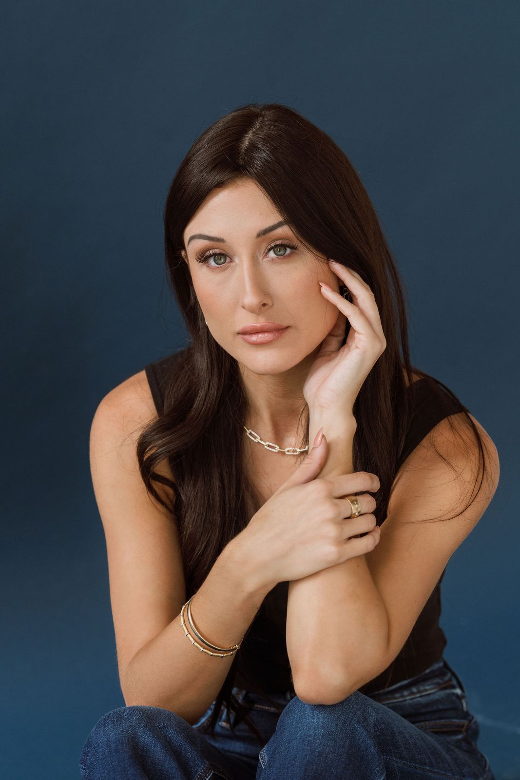 a woman sitting on the ground posing for a picture