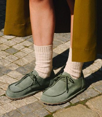 a close up of a person wearing green shoes