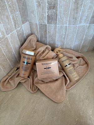 a couple of bottles of shampoo sitting on top of a towel