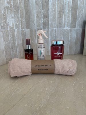 a bottle of lotion, a bottle of lotion and a towel on a