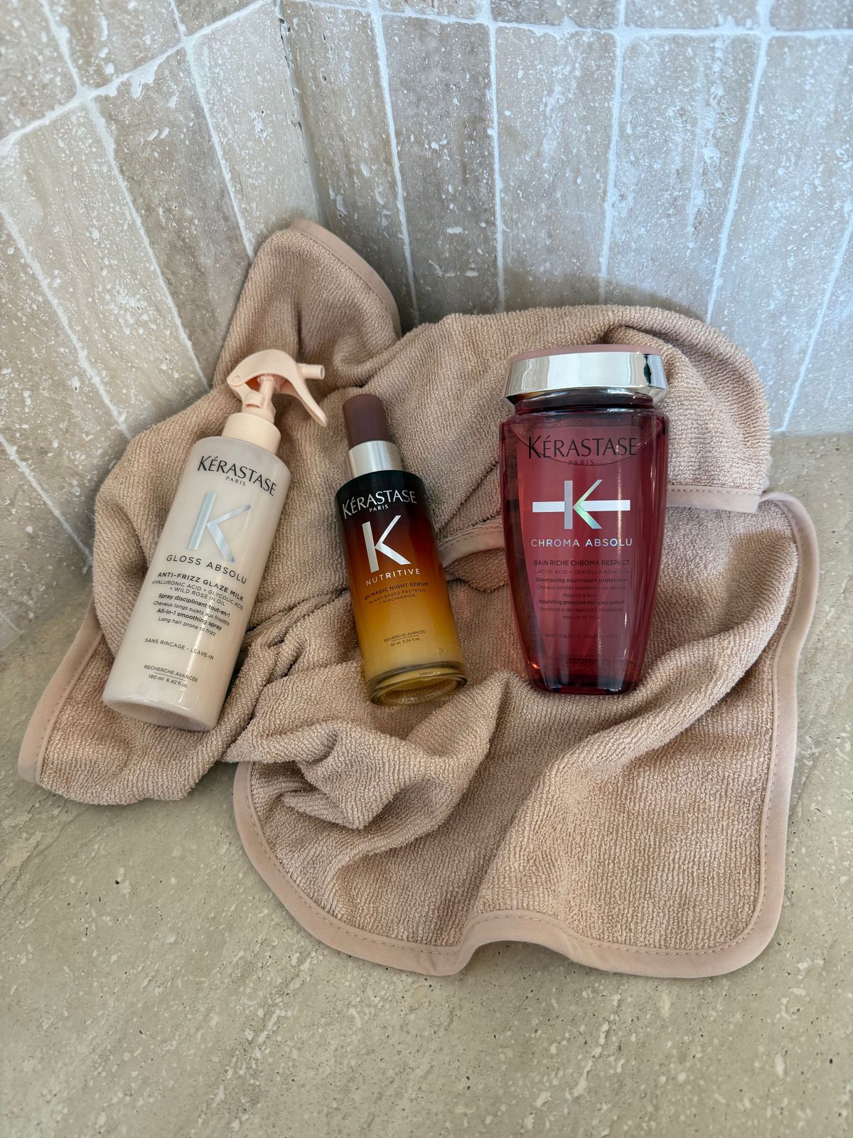 a bottle of kerastan and a bottle of kerastan on a towel
