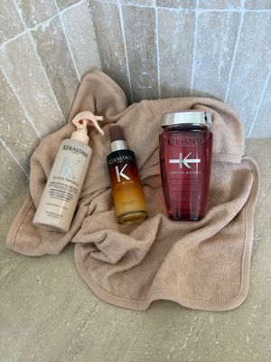 a bottle of kerastan and a bottle of kerastan on a towel